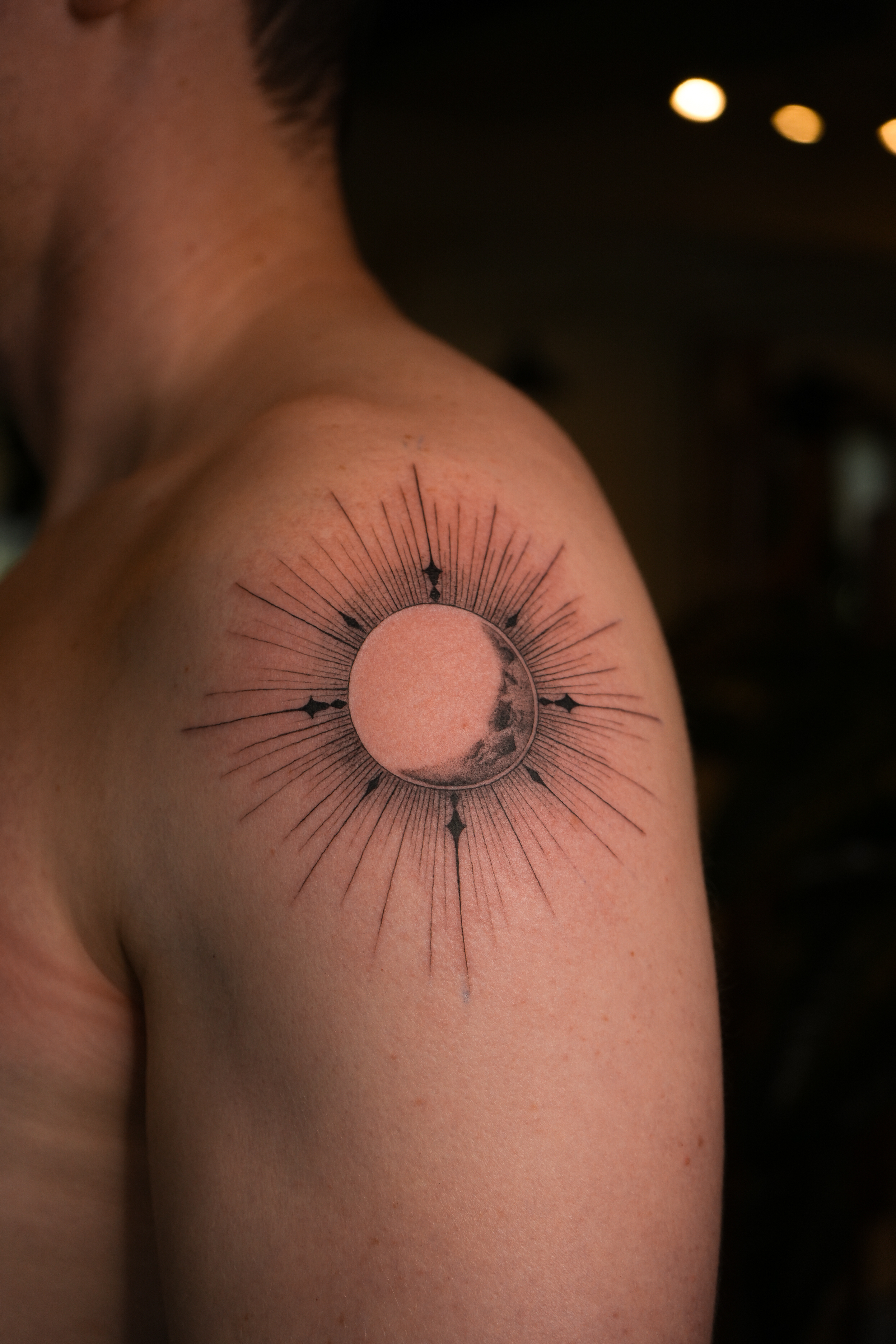 Moon with rays on shoulder